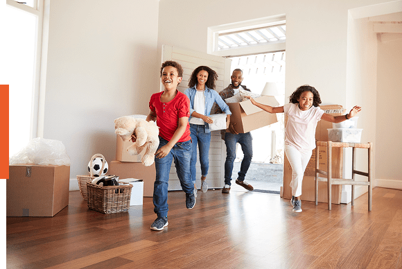 Family moving into new home, carrying boxes.