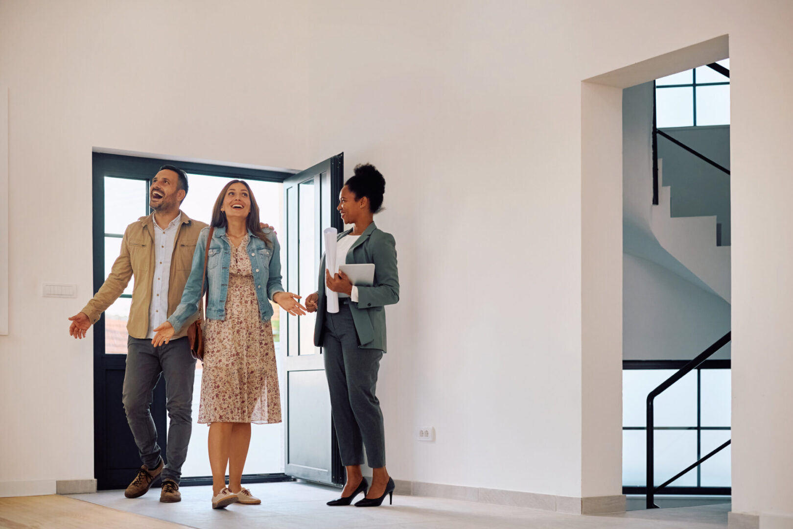 Wow, this house is amazing! Couple touring new home with real estate agent.